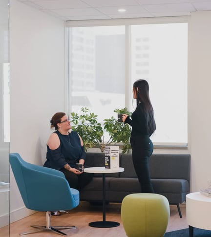 2 girls talking to each other at the office
